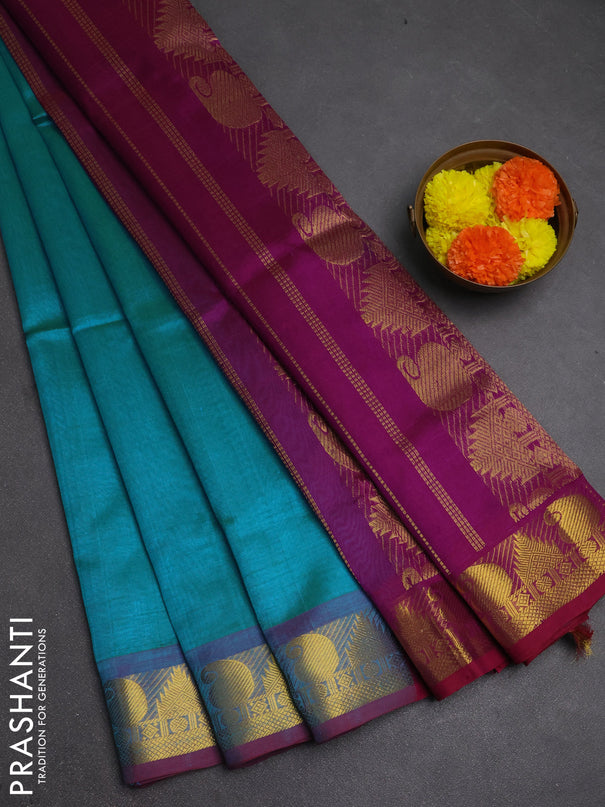 Silk cotton saree dual shade of teal blue and purple with plain body and paisley & temple zari woven border