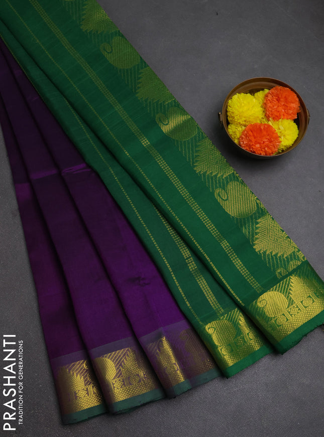 Silk cotton saree purple and green with plain body and paisley & temple zari woven border