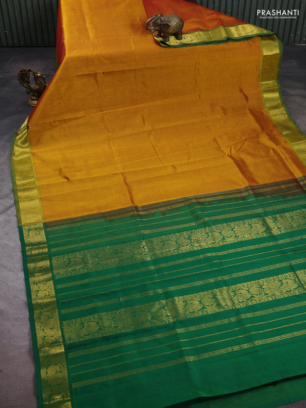 Silk cotton saree dark mustard and green with plain body and peacock zari woven border
