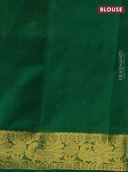 Silk cotton saree dark mustard and green with plain body and peacock zari woven border