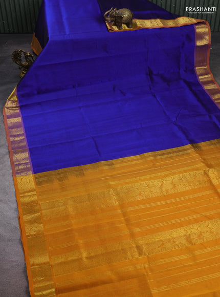 Silk cotton saree blue and mustard yellow with plain body and peacock zari woven border