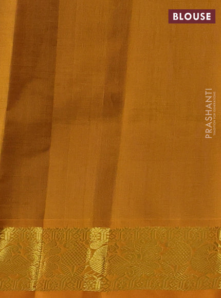 Silk cotton saree blue and mustard yellow with plain body and peacock zari woven border