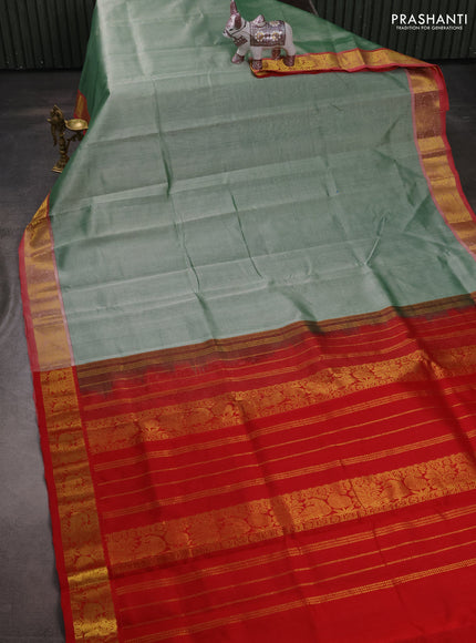 Silk cotton saree pastel green and red with plain body and peacock zari woven border