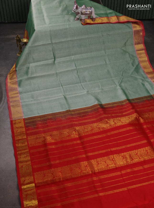 Silk cotton saree pastel green and red with plain body and peacock zari woven border