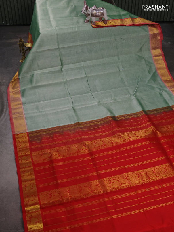 Silk cotton saree pastel green and red with plain body and peacock zari woven border