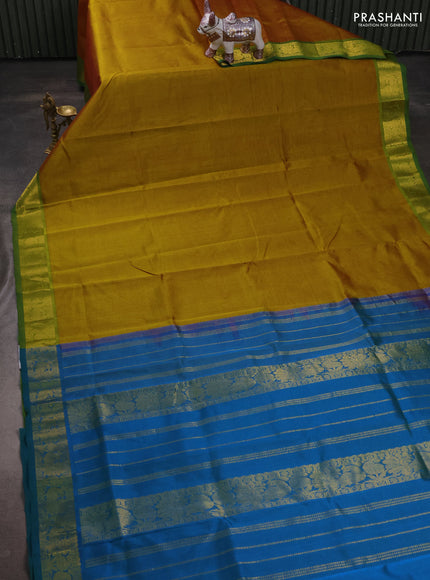 Silk cotton saree dark mustard and dual shade of bluish green with plain body and peacock zari woven border