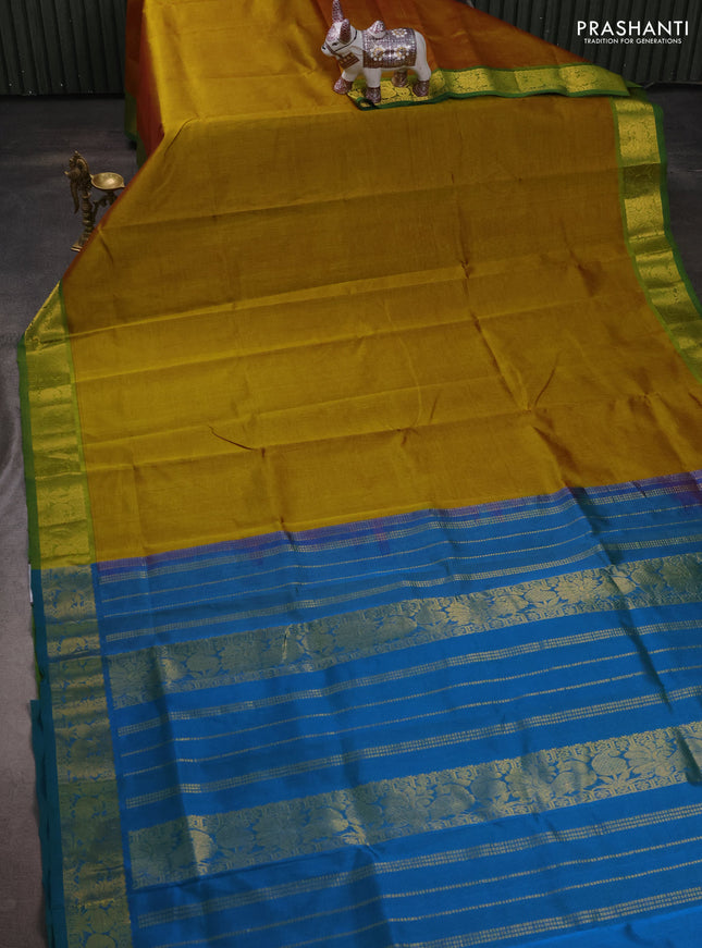 Silk cotton saree dark mustard and dual shade of bluish green with plain body and peacock zari woven border