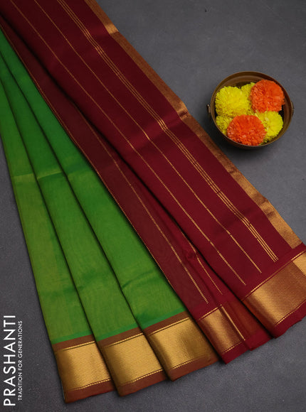 Silk cotton saree green and maroon with plain body and zari woven border