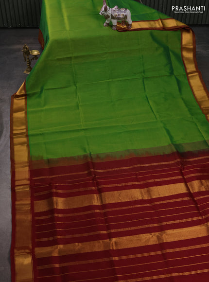 Silk cotton saree green and maroon with plain body and zari woven border