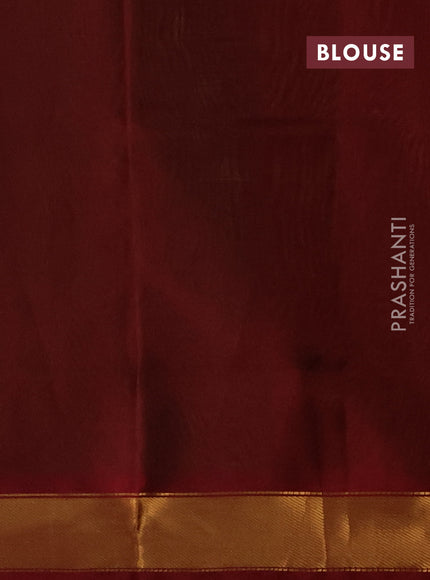 Silk cotton saree green and maroon with plain body and zari woven border