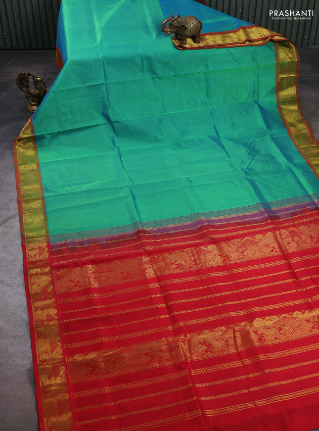 Silk cotton saree dual shade of teal green and red with plain body and zari woven border
