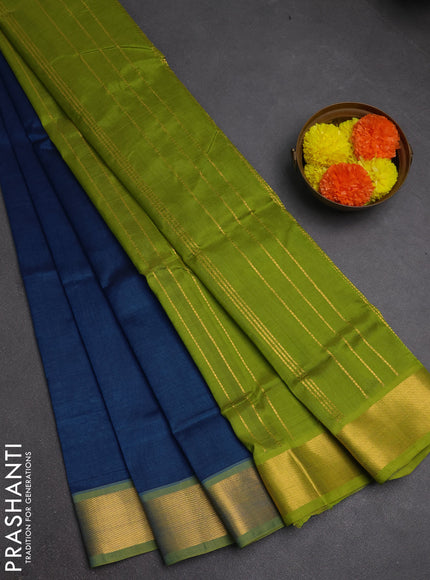 Silk cotton saree peacock blue and light green with plain body and zari woven border