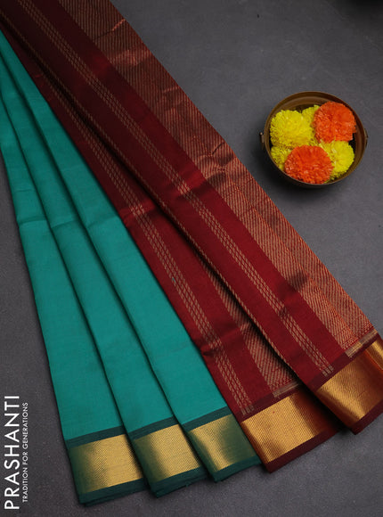 Silk cotton saree teal green and maroon with plain body and zari woven border