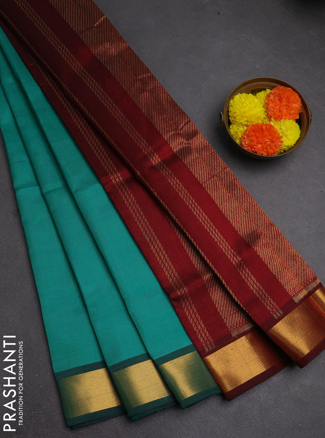 Silk cotton saree teal green and maroon with plain body and zari woven border