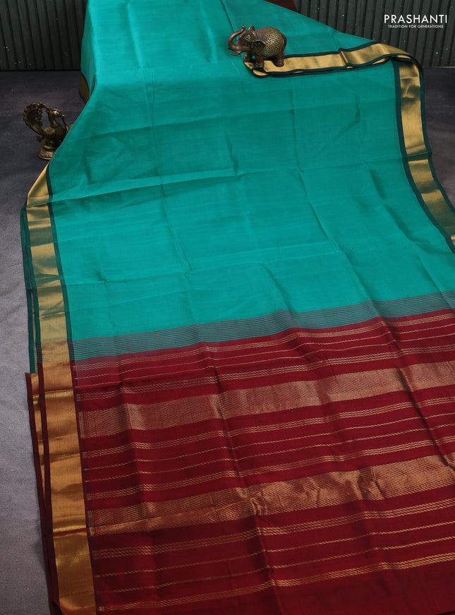 Silk cotton saree teal green and maroon with plain body and zari woven border