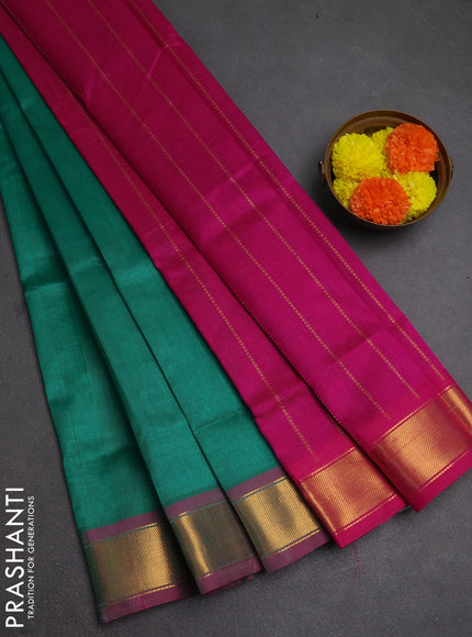 Silk cotton saree green and magenta pink with plain body and zari woven border