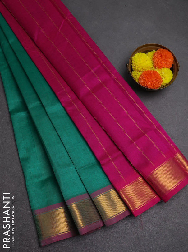 Silk cotton saree green and magenta pink with plain body and zari woven border
