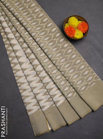 Ikat cotton saree cream and elaichi green with allover ikat zigzag weaves and simple border
