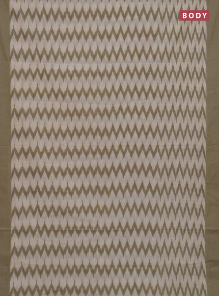 Ikat cotton saree cream and elaichi green with allover ikat zigzag weaves and simple border