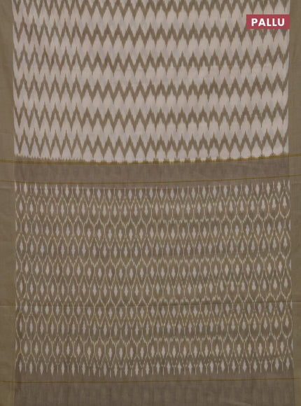 Ikat cotton saree cream and elaichi green with allover ikat zigzag weaves and simple border
