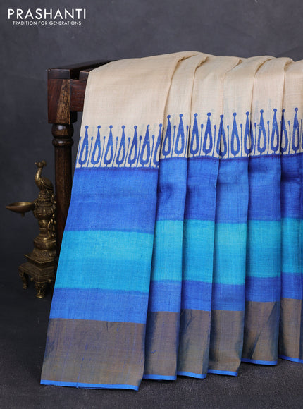 Pure tussar silk saree cream and blue wirh plain body and long printed zari border