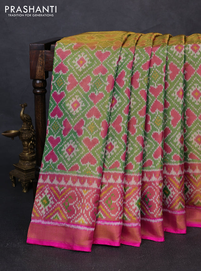 Rajkot patola tissue silk saree green and pink with allover ikat weaves and ikat woven zari border
