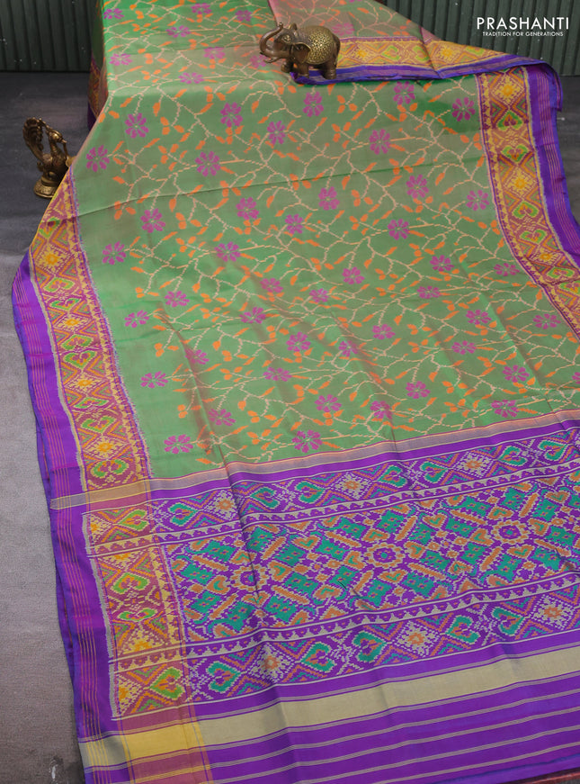 Rajkot patola silk saree dual shade of green and purple with allover ikat weaves and ikat woven zari border