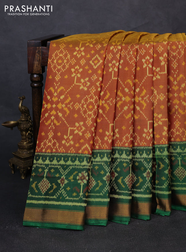Rajkot patola silk saree dual shade of dark mustard and purple green with allover ikat weaves and ganga jamuna border
