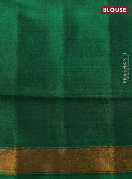 Rajkot patola silk saree dual shade of dark mustard and purple green with allover ikat weaves and ganga jamuna border