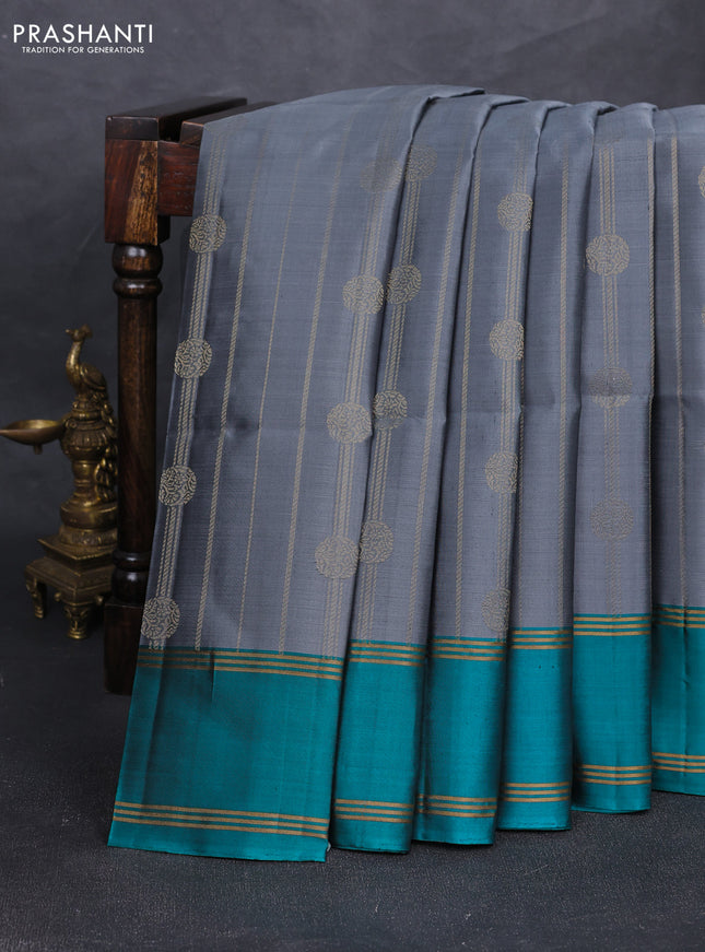 Pure soft silk saree grey and teal blue with allover zari stripes & buttas and rettapet zari woven border