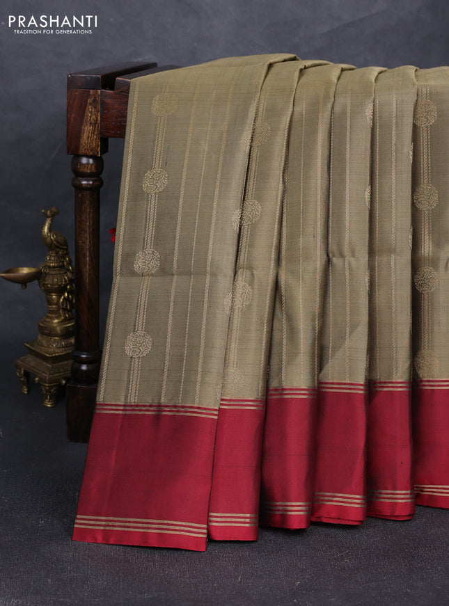 Pure soft silk saree olive green and red with allover zari stripes & buttas and rettapet zari woven border