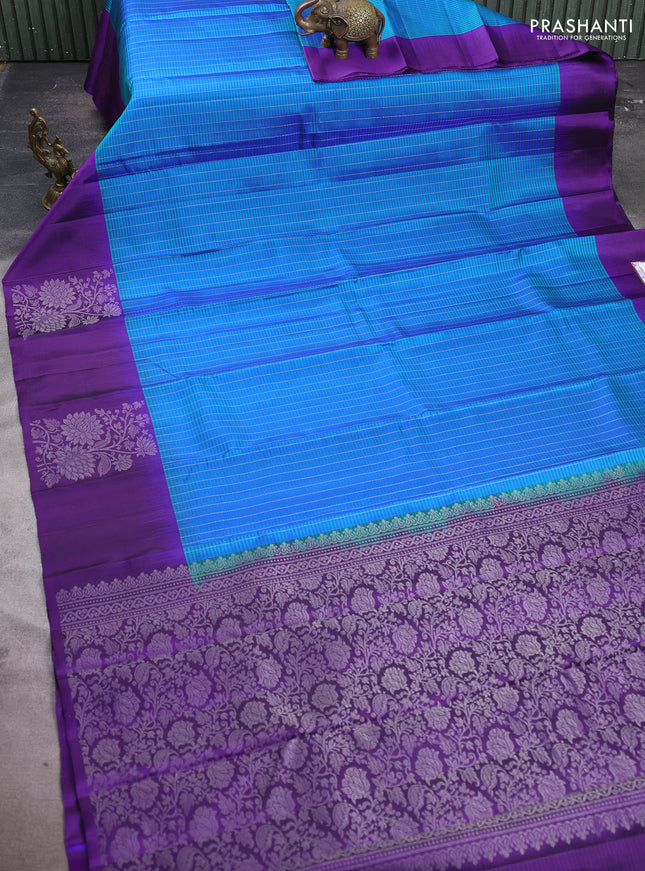 Pure soft silk saree dual shade of teal blue and deep violet with allover silver zari stripe pattern and long silver zari woven butta border