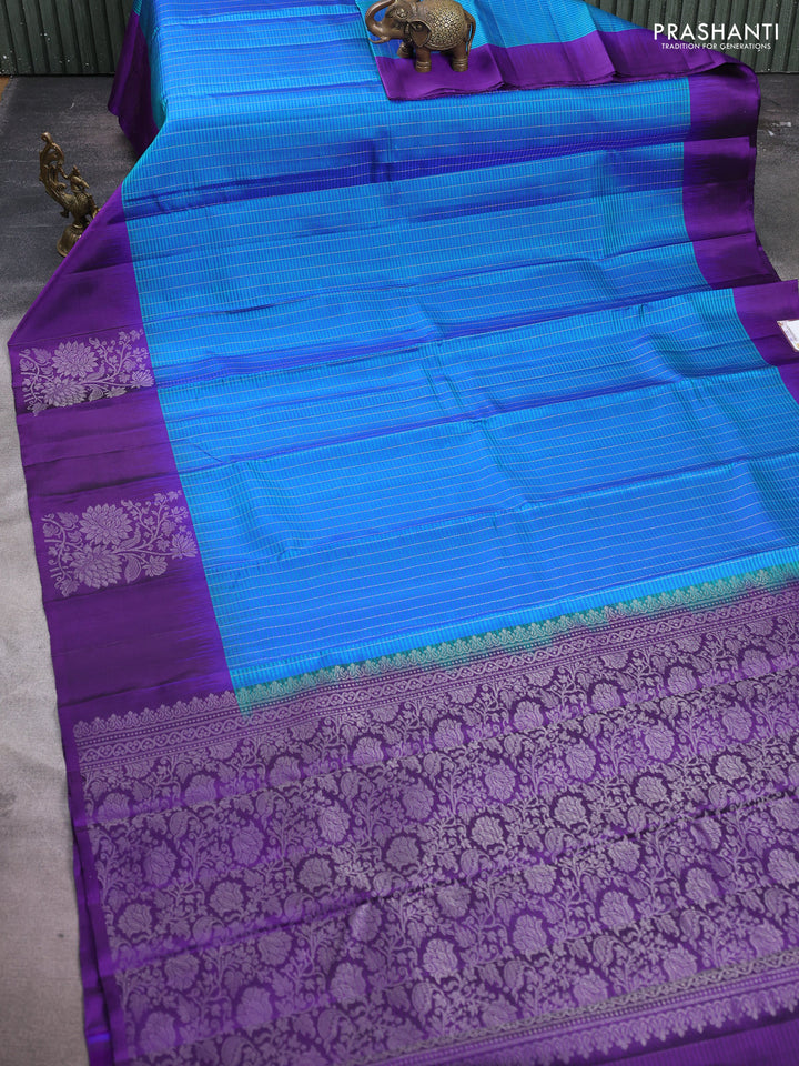 Pure soft silk saree dual shade of teal blue and deep violet with allover silver zari stripe pattern and long silver zari woven butta border