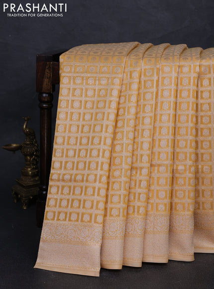 Banarasi silk cotton saree pale yellow with allover thread & zari checks & buttas and thread & zari woven border