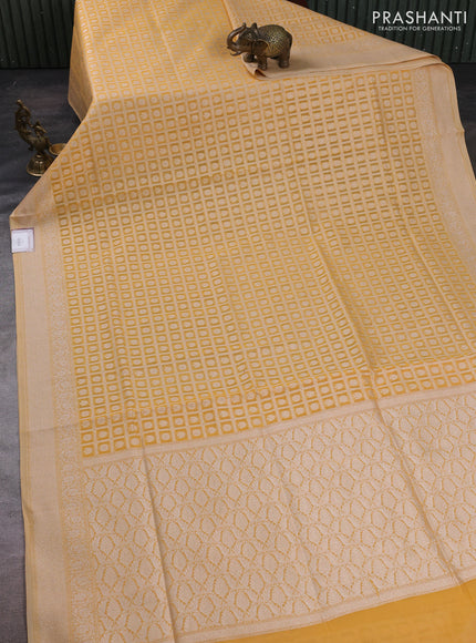 Banarasi silk cotton saree pale yellow with allover thread & zari checks & buttas and thread & zari woven border