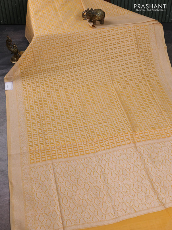 Banarasi silk cotton saree pale yellow with allover thread & zari checks & buttas and thread & zari woven border