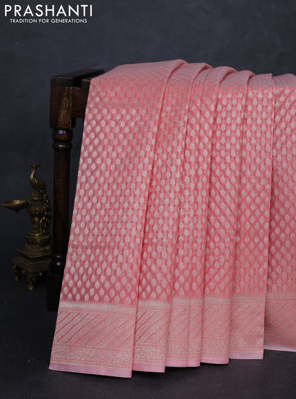 Banarasi silk cotton saree peach shade with allover zari woven buttas and zari woven border