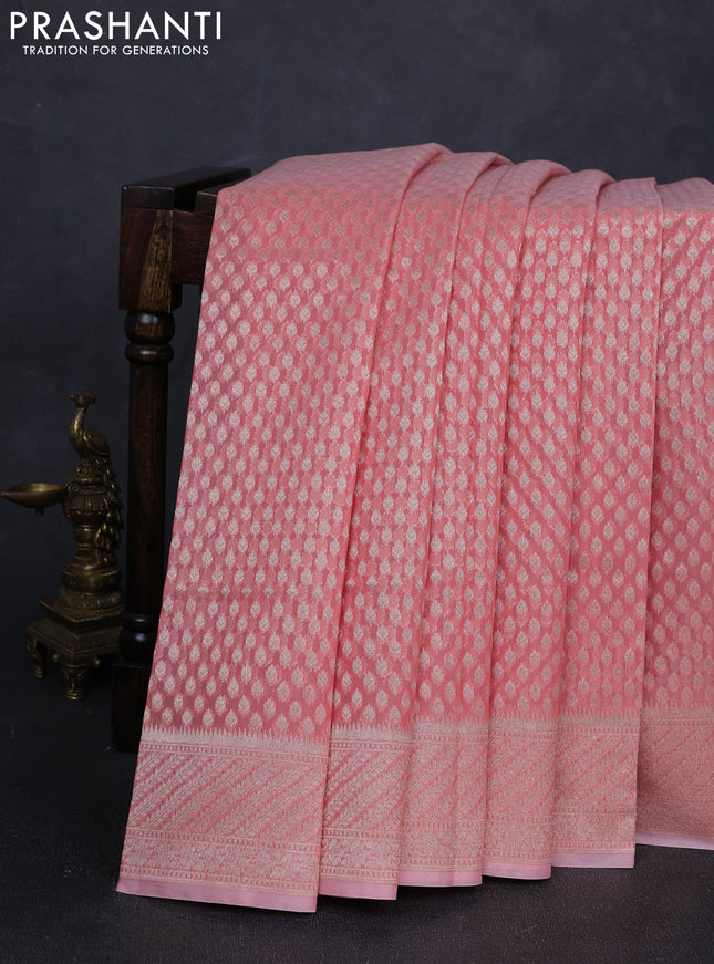 Banarasi silk cotton saree peach shade with allover zari woven buttas and zari woven border