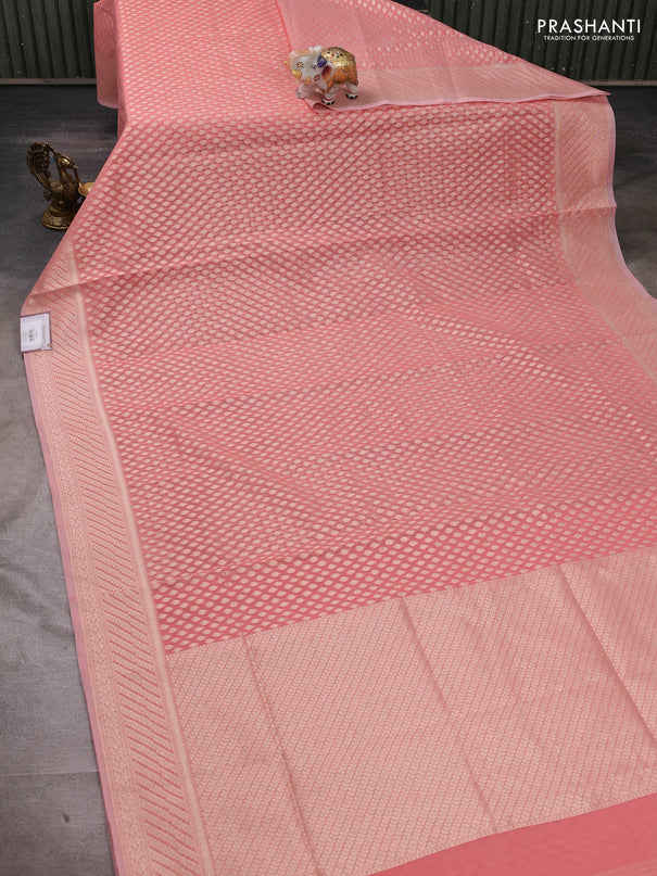 Banarasi silk cotton saree peach shade with allover zari woven buttas and zari woven border