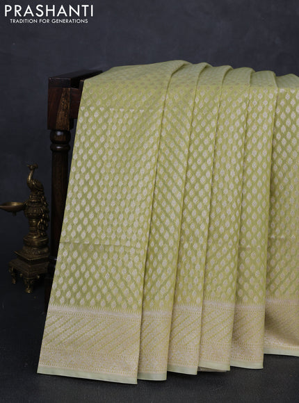 Banarasi silk cotton saree pista green with allover zari woven buttas and zari woven border