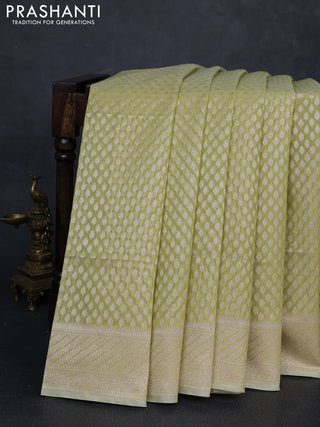 Banarasi silk cotton saree pista green with allover zari woven buttas and zari woven border