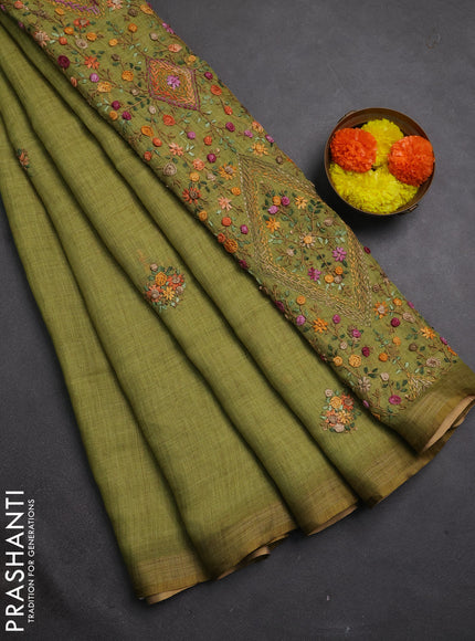 Tissue linen saree light green with embroidery buttas and embroidery pallu