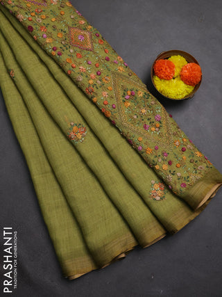 Tissue linen saree light green with embroidery buttas and embroidery pallu