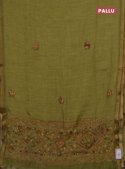 Tissue linen saree light green with embroidery buttas and embroidery pallu