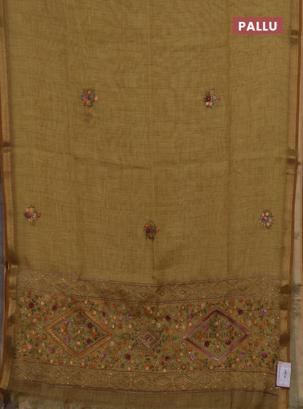 Tissue linen saree mustard green with embroidery buttas and embroidery pallu