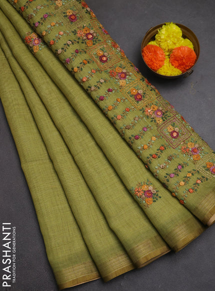Tissue linen saree light green with embroidery buttas and embroidery pallu