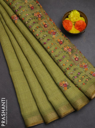 Tissue linen saree light green with embroidery buttas and embroidery pallu