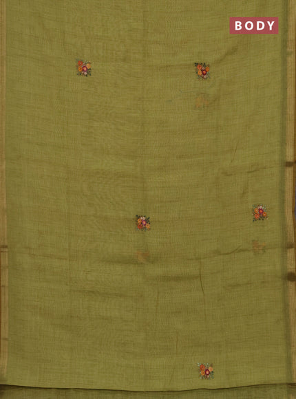 Tissue linen saree light green with embroidery buttas and embroidery pallu