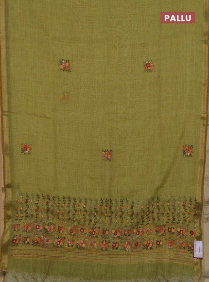 Tissue linen saree light green with embroidery buttas and embroidery pallu