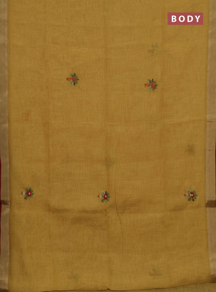 Tissue linen saree mustard green and maroon with embroidery buttas and embroidery pallu
